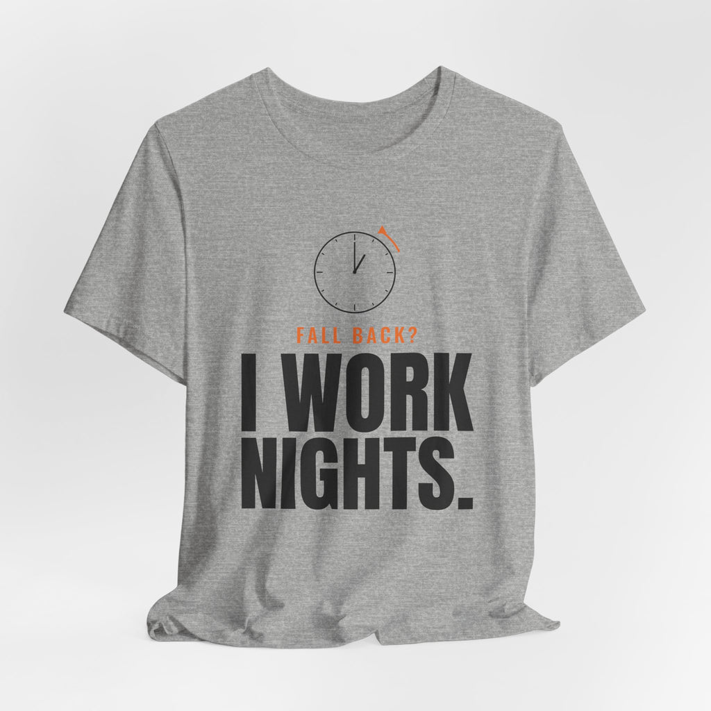 Heather gray night shift tee with a clock turning back and "FALL BACK? I WORK NIGHTS." in orange and bold type, on a soft gray backdrop