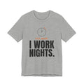 Heather gray night shift tee with a clock turning back and "FALL BACK? I WORK NIGHTS." in orange and bold type